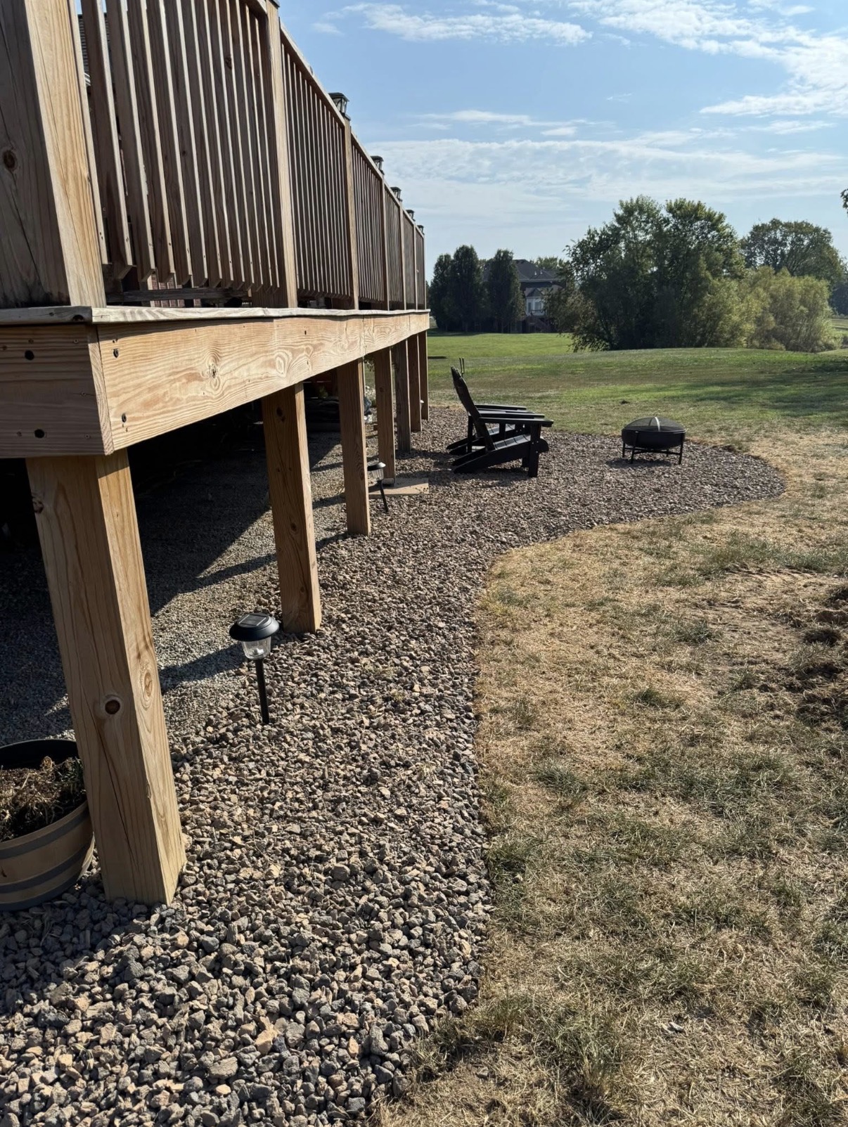 Backyard deck with gravel patio and fire pit
