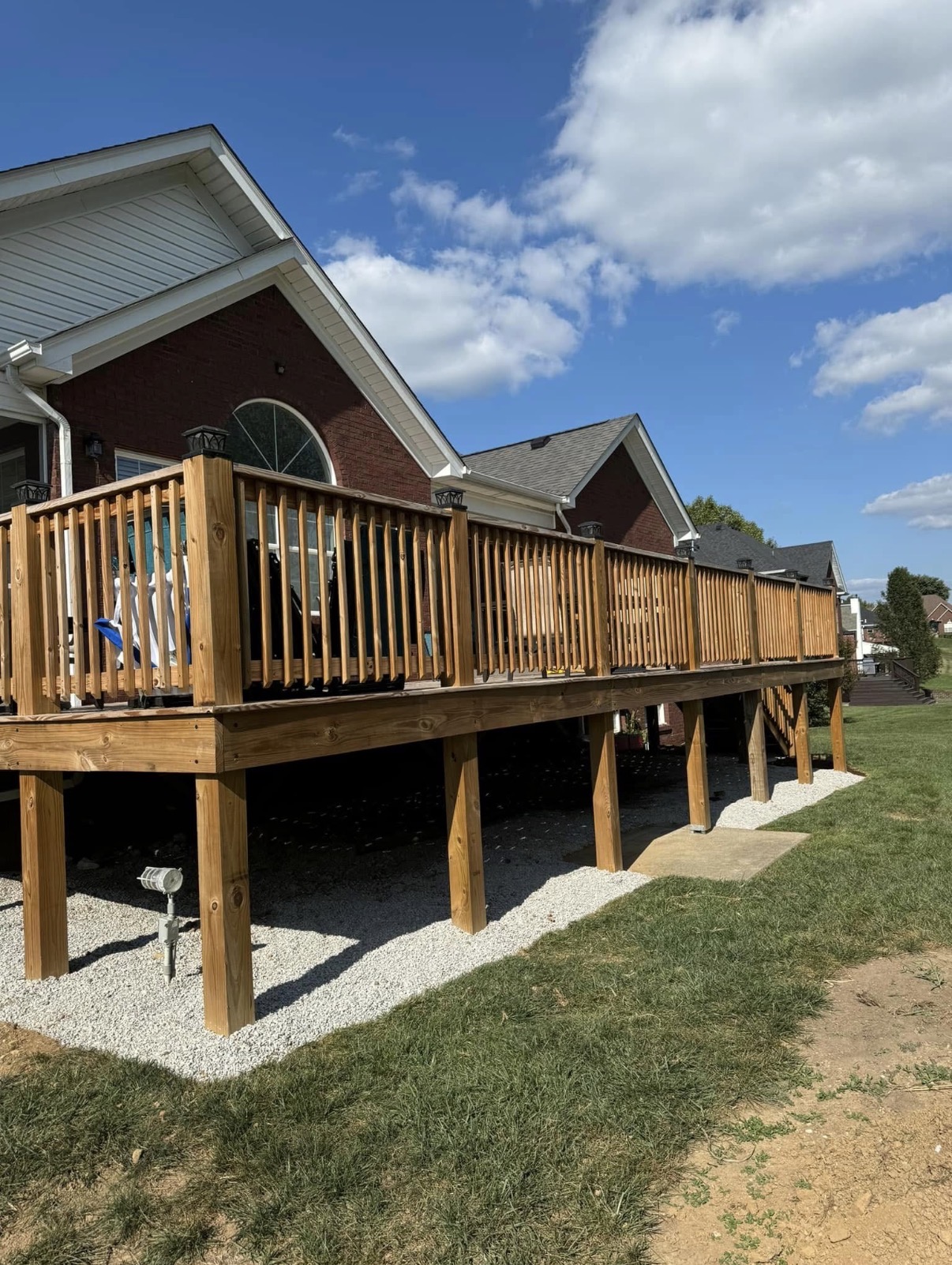 Custom wood deck with railing and gravel base
